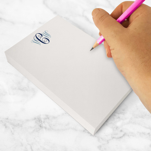 Custom stationery with feminine flair, shown with navy and french blue monogram in use with a pink pencil.
